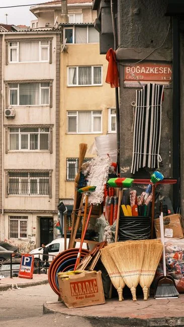 Open cardboard box with clothes by window, symbolizing moving or relocation.